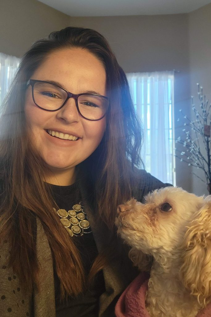 Emily with her dog Esme sitting on her lap